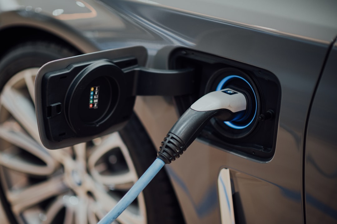 Electric vehicle charging cable plugged into a car at home